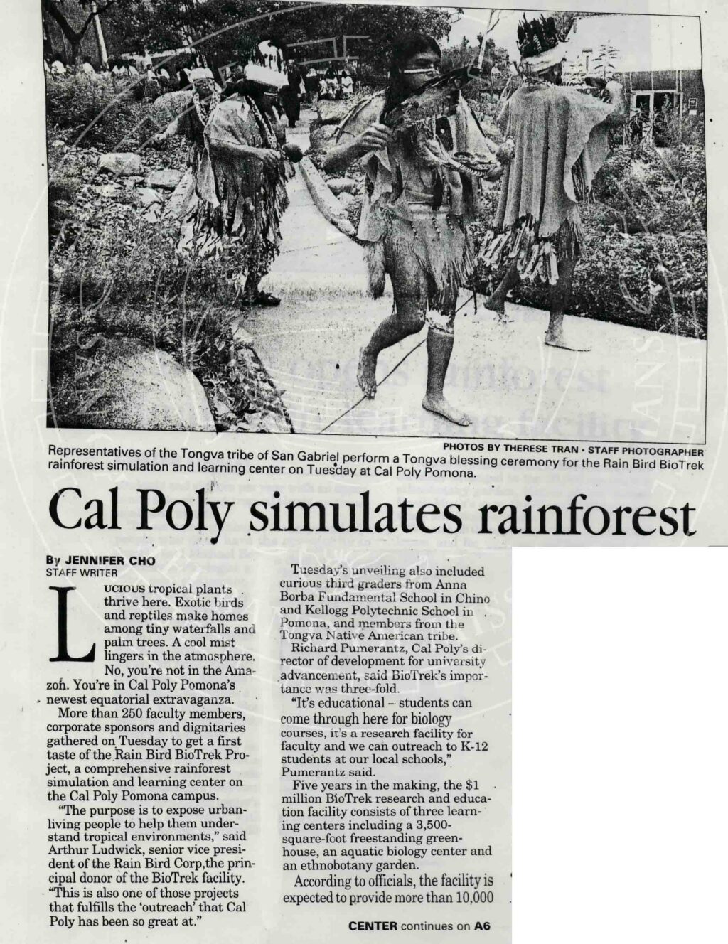 Facsimile of newspaper article entitled "Cal Poly simulates rainforest." Image shows dancers in traditional regalia with headdresses and feathered fans on a walkway.