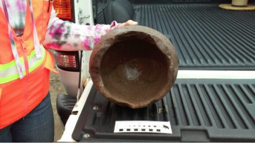 Top view of ancient stone pot displayed in bed of pickup truck
