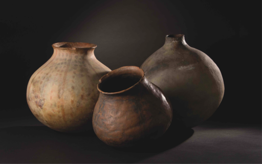 Three handmade clay pots, grey, brown, and beige with polychromatic designs