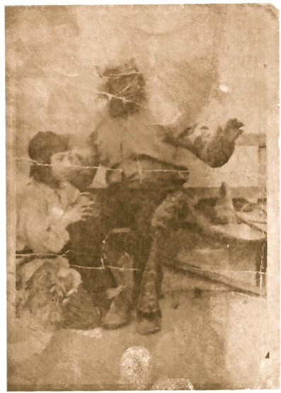 Old sepia-toned photograph of man and young boy in theatrical costumes
